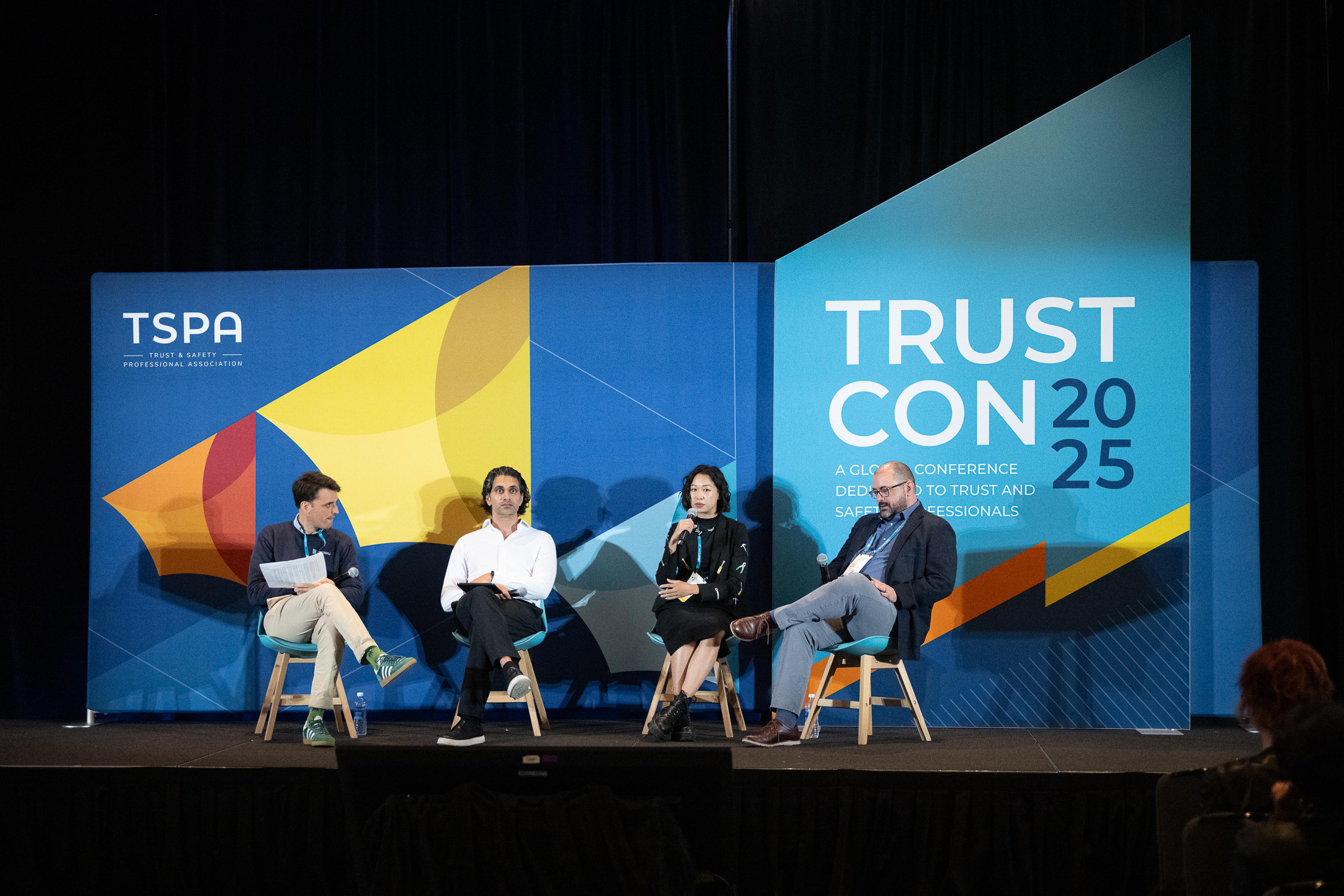 Panel discussion on stage at TrustCon 2025 conference.